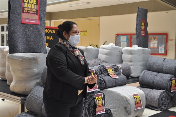 Diretora da escola, Livanéia Fernandes, ao lado dos 500 cobertores doados, em conjunto com o Estado passam de 100 mil doações da Fiesp