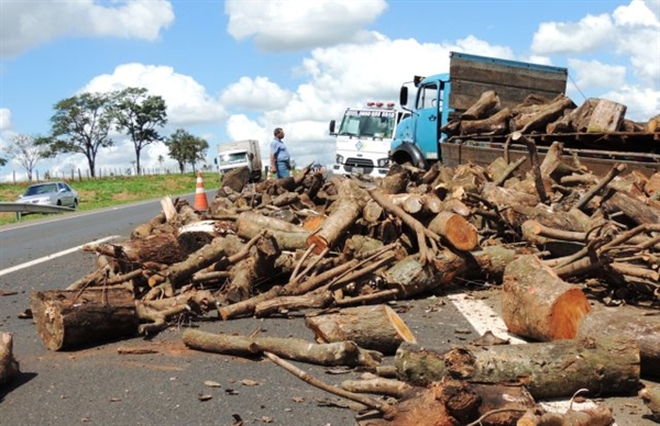 Pneu de caminhão estoura e carga de madeira cai na rodovia SP-320